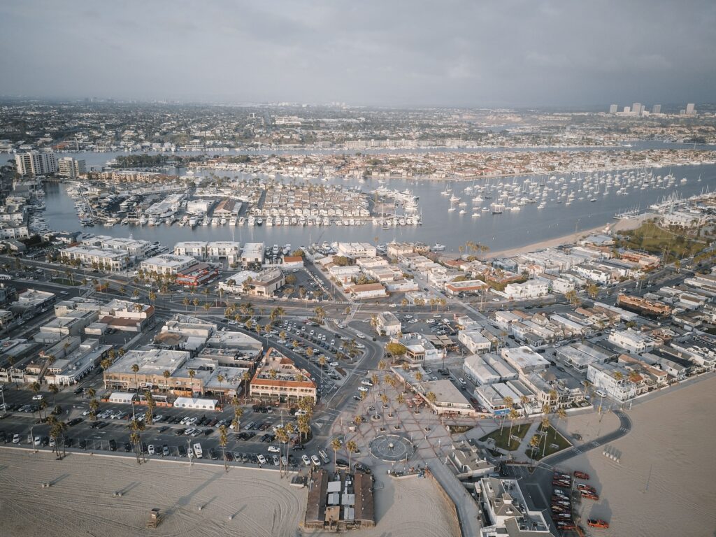 an aerial high-angle view of a bustling coastal city and harbor