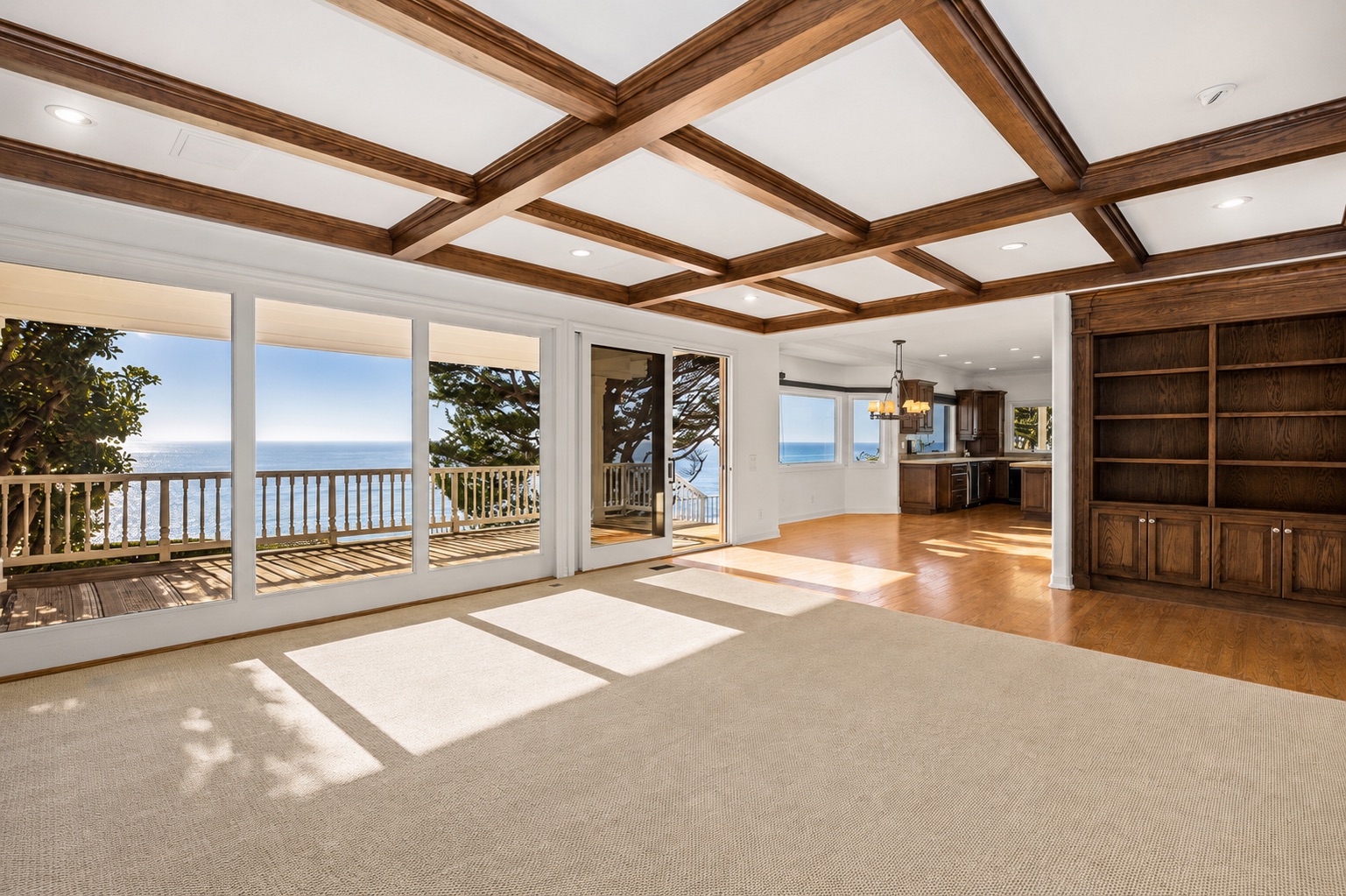 Living room before Compass Concierge work: worn carpet and dated finishes